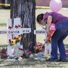 Una mujer coloca un animal de peluche junto a una cruz con el nombre de una víctima luego de un tiroteo masivo en la Escuela Primaria Robb en Uvalde, Texas, EE. UU., el 26 de mayo de 2022.