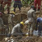 Bomberos trabajan en el área de un deslizamiento de tierra provocado por fuertes lluvias hoy, en el barrio Córrego do Jenipapo de la ciudad de Recife (Brasil).