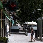 Una mujer pasa frente a una farmacia que marca 43 grados, en una imagen de archivo.