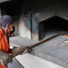 José Ortiz, un elaborador de "cholas", trabaja en el horneado de los panes, el 9 de junio de 2022, en Guano (Ecuador).