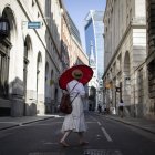 Una mujer usa un paraguas para protegerse del sol en el distrito financiero de la ciudad de Londres, Reino Unido