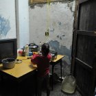 Fotografía de archivo fechada el 10 de septiembre de 2008 que muestra a una niña mientras lava platos en una improvisada cocina en el poblado José Martí, municipio de San Cristóbal, provincia de Pinar del Río (Cuba).