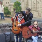 LEOPOLIS (UCRANIA), 26/10/2022.-Andriy Saravas, un músico de Mariúpol de etnia griega, ofrece clases de guitarra para los niños en el centro de asistencia "Yo soy Mariúpol" en una estrecha calle en el centro de Leópolis. El centro trata de ayudar a niños y a adultos a través del aprendizaje de nuevas habilidades, explorando la ciudad de Leópolis o a través de la interacción con animales. Según el presidente del centro, Andriy Vasylenko, en el mismo se han registrado ya más de 3.100 desplazados de Mariúpol, la mayoría de los cuales han perdido todas sus pertenencias y dependen de la ayuda que reciben de organizaciones humanitarias y de los residentes locales en forma de alimentos, ropas o incluso sillas de ruedas para las personas con discapacidad. También acuden al centro para recuperar, al menos temporalmente, la sensación de estar en casa y para recibir ayuda psicológica. EFE/ Rostyslav Averchuk