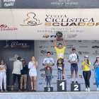 El ciclista colombiano Robinson Chalapud (c) con el maillot amarillo y el trofeo como campeón de la Vuelta al Ecuador.