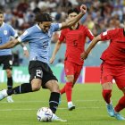 Edinson Cavani (i) de Uruguay disputa un balón con Kim Young-gwon de Corea del Sur hoy, en un partido de la fase de grupos del Mundial de Fútbol Qatar 2022 entre Uruguay y Corea del Sur en el estadio Ciudad de la Educación en Rayán (Qatar).
