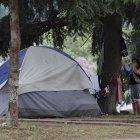 Una mujer en situación de calle cuelga su ropa en un parque público en el que acampa, hoy, en Santiago (Chile). El 32,1 % de la población total de la región, lo que equivale a 201 millones de personas, vivirá en situación de pobreza para finales de este año, de los que 82 millones (13,1 %) se encontrarán en pobreza extrema, informó este jueves la Comisión Económica para América Latina y el Caribe (Cepal). EFE/ Elvis González