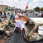 Simpatizantes de Pedro Castillo caminan entre dos vehículos incinerados mientras se manifiestan para pedir la salida de la presidenta Dina Boluarte y el cierre del Congreso hoy, en el distrito de la Joya, en Arequipa (Perú). Dieciocho personas han muerto desde que este domingo comenzaron las manifestaciones y protestas que exigen el adelanto de elecciones, la renuncia de la presidenta Dina Boluarte, el cierre del Congreso y la convocatoria a una asamblea constituyente. EFE/ José Sotomayor Jiménez