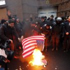 Personas queman una bandera de Estados Unidos durante una protesta frente a la embajada de Francia en Teherán /EFE