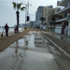 Personal del Municipio de Santa Elena trabaja con maquinaria para poder retirar la arena de la playa que se encuentra en la vía