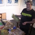 Caso. El dibujante y escultor argentino Julio Rayón posa con varios de los álbumes de cromos que colecciona.