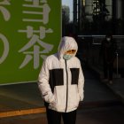Una mujer con mascarilla camina por la calle en Pekín el 16 de enero de 2023. EFE/EPA/WU HAO