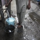 Un hombre llena unos cubos de agua en una fuente en un mercado en Amritsar (India), en una fotografía de archivo.