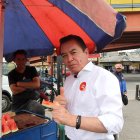 Chillogallo. Previo al inicio del recorrido, el candidato degusta de una porción de sandía, en un puesto ambulante del sector