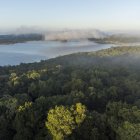 Fotografía panorámica de la laguna Yaxhá en la selva de Petén donde se albergan animales y el parque arqueológico de Yaxhá, el 02 de febrero de 2023 en Petén (Guatemala). Organizaciones comunitarias en el norte de Guatemala ofrecen servicios de ecoturismo en el sitio arqueológico de Yaxhá, en el extremo noreste del país centroamericano y son respaldados por instituciones estatales para prevenir los incendios forestales que amenazan esta zona selvática. EFE/ Esteban Biba