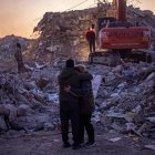 Una pareja observa los escombros que dejó el terremoto en Hatay.
