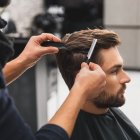 Male client getting haircut by hairdresser