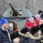 Un grupo de niños posan para una foto en un vehículo de combate de infantería durante el Día del Defensor de la Patria en Victory Park en San Petersburgo, en Rusia, el 23 de febrero de 2023.