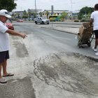 Pedro Ruiz, quien reside en la manzana 3021 de Las Orquídeas, muestra el hundimiento que ha sufrido la calzada cerca de su vivienda, lo que representa un peligro para los peatones.