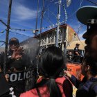 Policías estadounidenses acuden a controlar una protesta de cientos de migrantes.