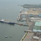 VISTA PANORÁMICA O AÉREA DE PUERTO MARÍTIMO CON SUS MUELLES Y BUQUES DE CARGA.