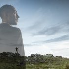 Looking on. Businessman with landscapes on background, double exposure. Lives in megapolis but needs to find herself face to face with nature. Dreams about mental balance. Psycology, eco concept.