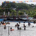 Un grupo de personas se refrescan en una psicina ante la ola de calor.