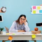 Deadline and multitask concept. Tired asian lady stressed by a lot of work, sitting at the desk over blue background and looking at camera. Hands with tablet, watch, tasks and smartphone