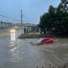 Vista general hoy, donde se observa un auto cubierto de agua en una de las calles en Baja California (México). La península de Baja California resintió este domingo los primeros efectos de Hilary, que tocó tierra como huracán categoría 1 y horas después se degradó a tormenta tropical, y provocó daños en viviendas, inundaciones y suspensiones en el servicio eléctrico en diversos municipios, además de la muerte de una persona el sábado. EFE/Alejandro Zepeda