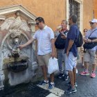 Turistas beben en una fuente, este viernes en Roma.