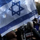 A woman holds an Israeli flag during a candlelight vigil for Israeli victims in New York, New York, USA, 01 November 2023. Thousands of Israelis and Palestinians have died since the militant group Hamas launched an unprecedented attack on Israel from the Gaza Strip on 07 October, and the Israeli strikes on the Palestinian enclave which followed it.