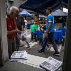 Caracas.  Un hombre toma un periódico del camión de información.