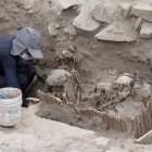 Aarqueólogos mientras trabajan con momias halladas en una pirámide prehispánica, en Lima (Perú).