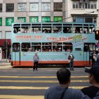 Hong Kong (China), 10/12/2023.- A tram displaying the advertisement of the District Council Ordinary Election drives past in Hong Kong, China, 10 December 2023. This is the first election after its reform in May 2023 which aims at ensuring only "patriots" are elected. The directly elected seats will be slashed to around 20 percent under the electoral overhaul. (Disturbios) EFE/EPA/BERTHA WANG