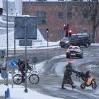 Varias personas cruzan una calle durante las nevadas en Randers, en la península de Jutlandia, Dinamarca, el 17 de enero de 2024.