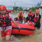 Los bomberos rescatan en una boya a un grupo familiar que estaba atrapado en su casa por la inundación.