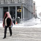 Nueva York. Una persona camina por una calle cubierta por la nieve.
