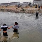 Migrantes se preparan para cruzar el Río Bravo, en la frontera que divide a México de los Estados Unidos, en un punto de Texas