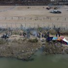 Varios migrantes aparecen en las inmediaciones del Río Bravo, junto al alambrado que divide a México con Estados Unidos, este miércoles, en Ciudad Juárez (México).