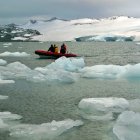 Una lancha ligera recorre, entre trozos del deshielo, las aguas que rodean la Antártida.