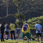 Seguidores del automovilista brasileño Ayrton Senna muestran respeto frente a la tumba del piloto