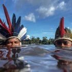 El cacique Jonas Mura de la aldea de Gavião Real bucea en el río Urubú con su hijo Jonas, el 14 de junio del 2024, en la selva amazónica (Brasil).
