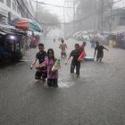 Residentes caminan en una zona inundada tras las lluvias monzónicas en Manila, Filipinas, el 24 de julio de 2024.