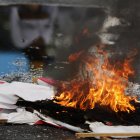 Fotografía de un cartel en llamas durante una protesta por los resultados de las elecciones presidenciales este lunes, en Caracas (Venezuela).