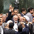 Líder de Hamás, Ismail Haniyeh, (C), en la que hace el signo de la victoria rodeado de legisladores iraníes.