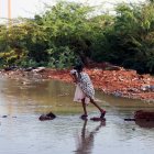 Una persona intenta atravesar una zona rural inundada en este país africano.