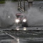 Un auto circula por una calle inundada por el paso del huracán Ernesto este miércoles, en San Juan, Puerto Rico.