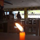 En las mesas de un restaurante se colocaron velas por la falta de luz. La afluencia de clientes disminuyó en comparación con un día normal.
