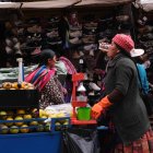 AME8177. LA PAZ (BOLIVIA), 01/01/2025.- Fotografía del 20 de diciembre de 2024 de una mujer aimara vendiendo jugos naturales en una calle de La Paz (Bolivia). Bolivia tiene en 2025 el reto de levantar su economía golpeada en el año precedente por la inflación, las dificultades de abastecimiento de carburantes y una falta de dólares que persiste desde 2023, problemas que el Gobierno confía en revertir, aunque expertos consideran que esto solo se logrará si se toman medidas resistidas por el Ejecutivo, como la reducción del gasto público. EFE/ Luis Gandarillas