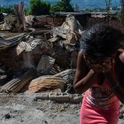 Una mujer llora afuera de su casa después de que bandas armadas la incendiaran en el barrio de Post Marchand de Puerto Príncipe el 17 de diciembre de 2024.