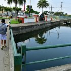 Un canal que colinda con la entrada de la urbanización se suele desbordar.